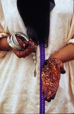Marrakesh woman shows henna designs on hands